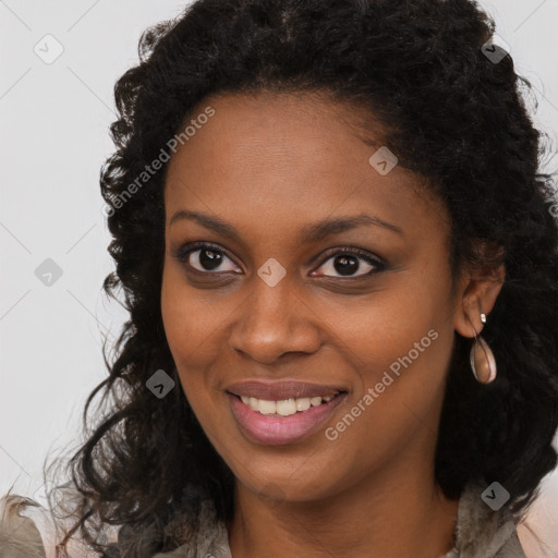 Joyful black young-adult female with long  brown hair and brown eyes