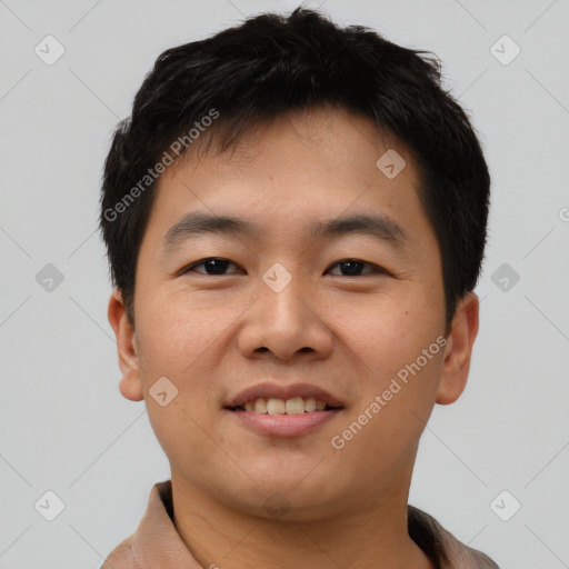 Joyful asian young-adult male with short  black hair and brown eyes