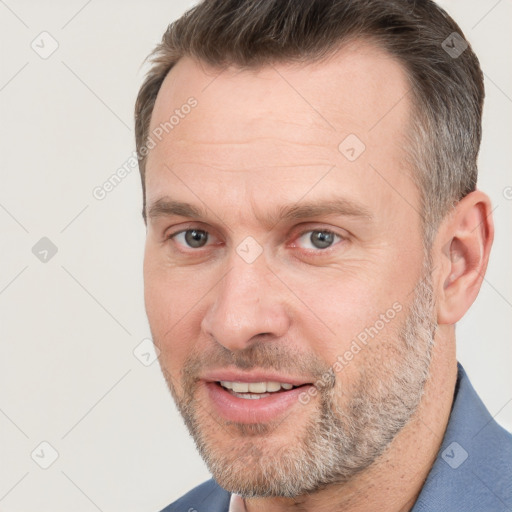 Joyful white adult male with short  brown hair and grey eyes