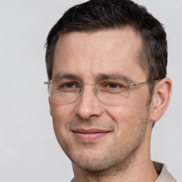 Joyful white adult male with short  brown hair and brown eyes