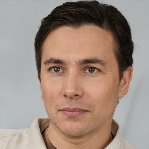 Joyful white adult male with short  brown hair and brown eyes