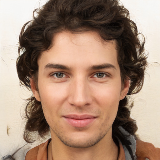 Joyful white young-adult male with medium  brown hair and brown eyes