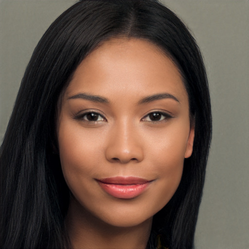 Joyful latino young-adult female with long  black hair and brown eyes