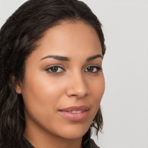 Joyful latino young-adult female with long  brown hair and brown eyes