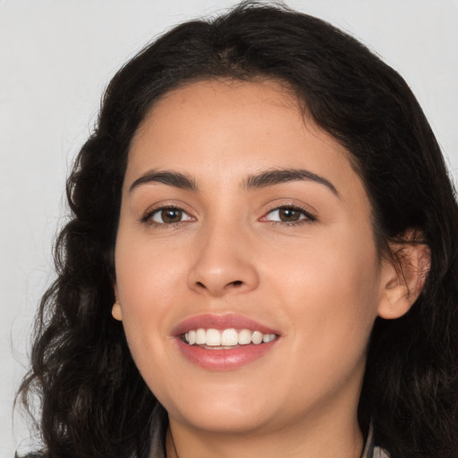 Joyful white young-adult female with long  brown hair and brown eyes