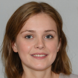 Joyful white young-adult female with medium  brown hair and blue eyes