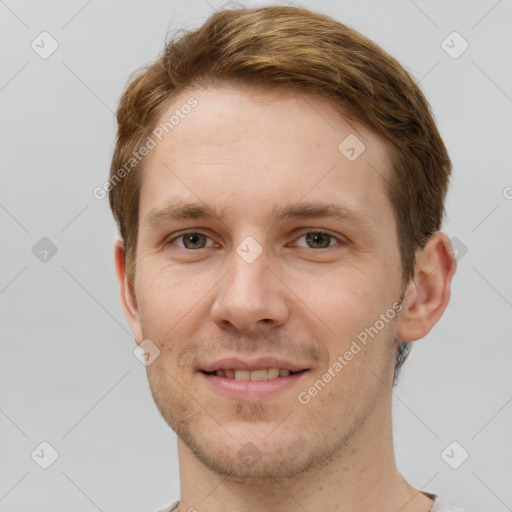 Joyful white young-adult male with short  brown hair and grey eyes