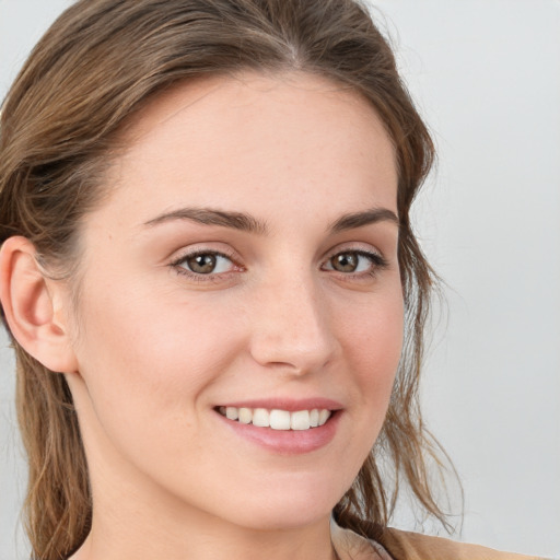 Joyful white young-adult female with long  brown hair and grey eyes