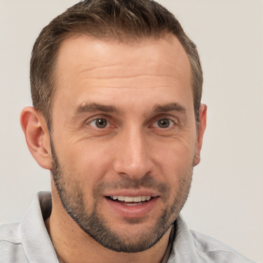 Joyful white adult male with short  brown hair and brown eyes