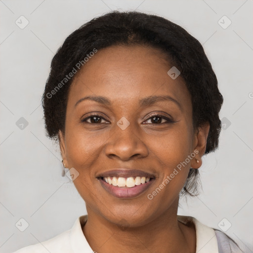 Joyful black adult female with short  brown hair and brown eyes