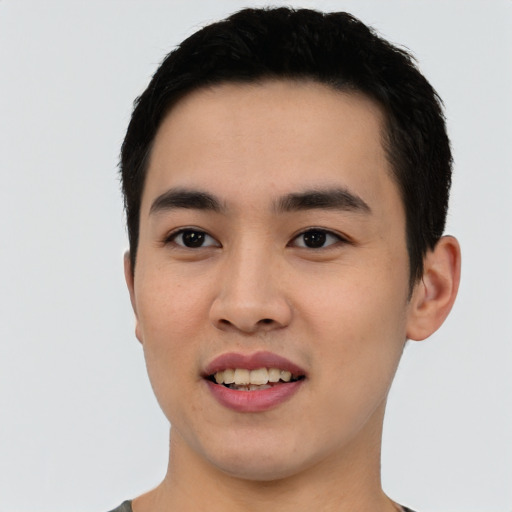 Joyful asian young-adult male with short  black hair and brown eyes