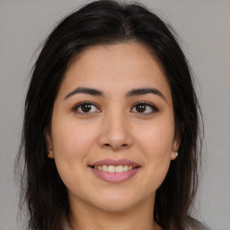 Joyful white young-adult female with long  brown hair and brown eyes