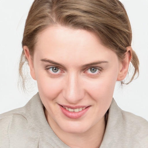 Joyful white young-adult female with medium  brown hair and blue eyes