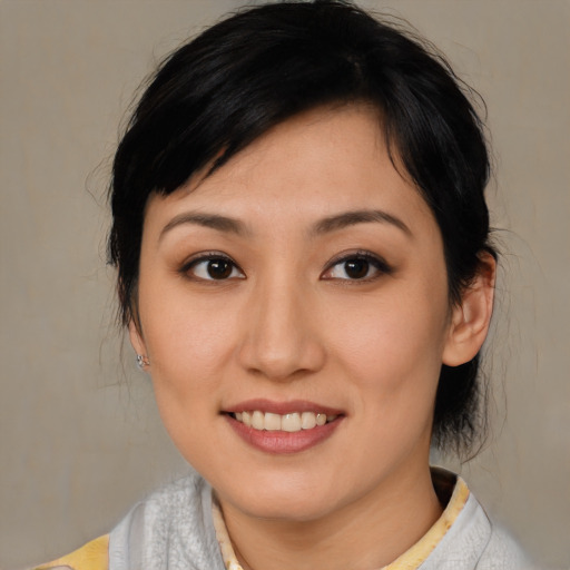 Joyful asian young-adult female with medium  brown hair and brown eyes