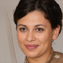 Joyful white adult female with medium  brown hair and brown eyes