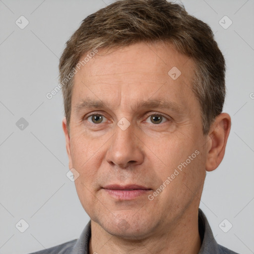 Joyful white adult male with short  brown hair and brown eyes