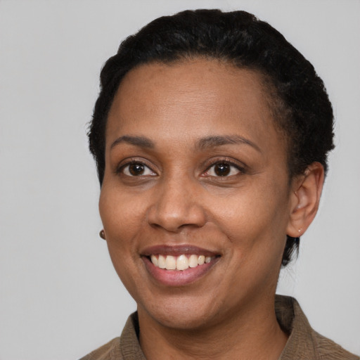 Joyful latino adult female with short  black hair and brown eyes