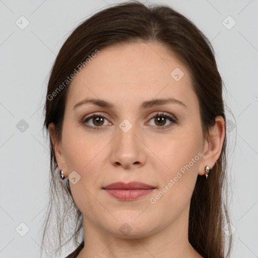 Joyful white young-adult female with long  brown hair and brown eyes