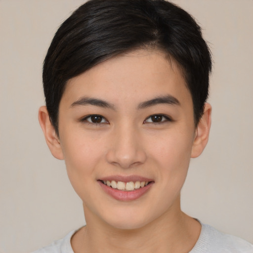 Joyful asian young-adult female with short  brown hair and brown eyes