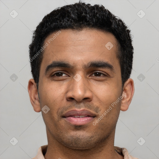 Joyful latino young-adult male with short  black hair and brown eyes