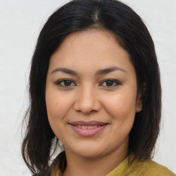 Joyful latino young-adult female with medium  brown hair and brown eyes