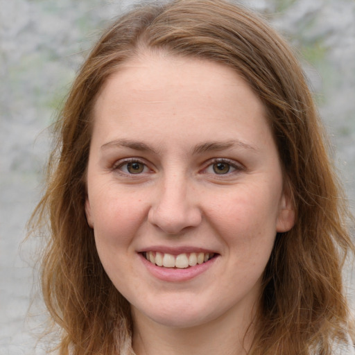 Joyful white young-adult female with medium  brown hair and blue eyes