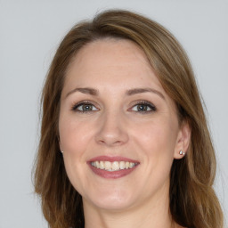 Joyful white young-adult female with long  brown hair and grey eyes