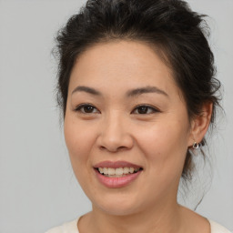 Joyful white young-adult female with medium  brown hair and brown eyes