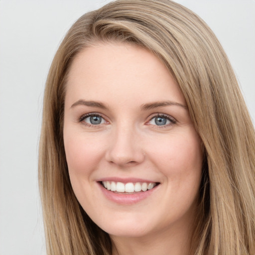 Joyful white young-adult female with long  brown hair and grey eyes