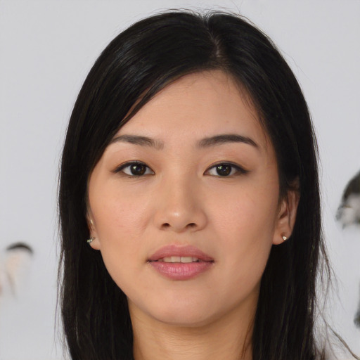 Joyful asian young-adult female with long  black hair and brown eyes