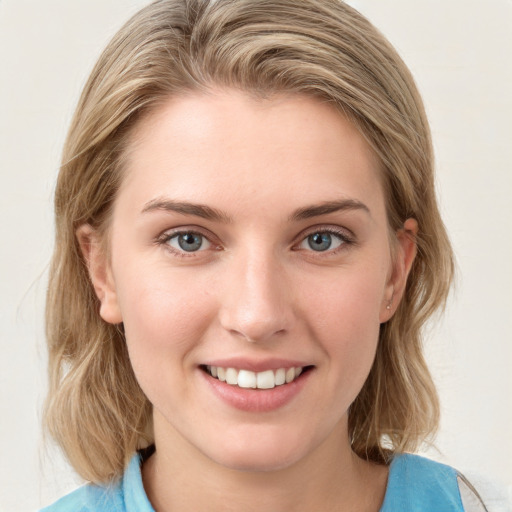 Joyful white young-adult female with medium  brown hair and blue eyes