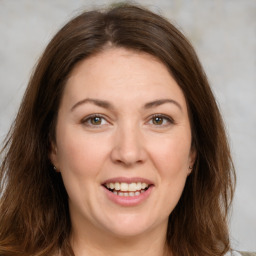 Joyful white young-adult female with medium  brown hair and green eyes