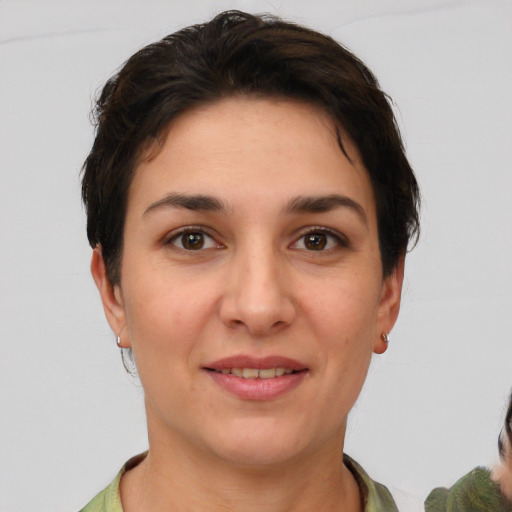 Joyful white young-adult female with short  brown hair and brown eyes