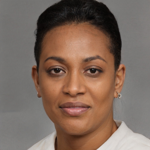 Joyful black young-adult female with short  black hair and brown eyes