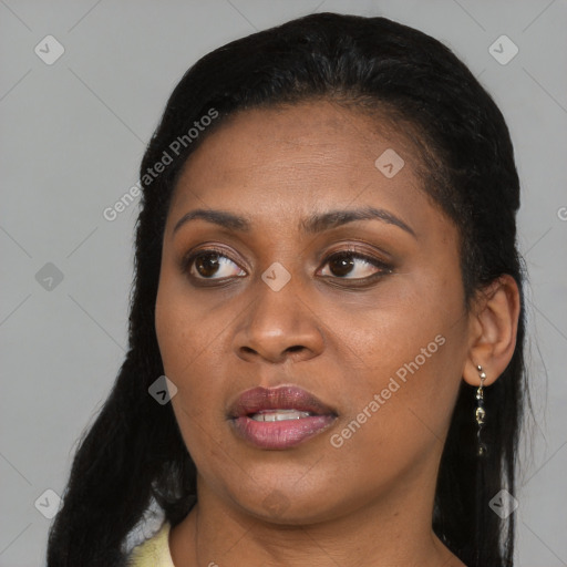 Joyful black young-adult female with long  black hair and brown eyes