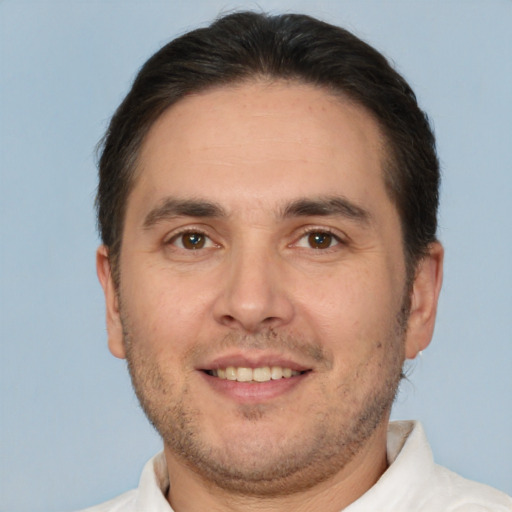 Joyful white adult male with short  brown hair and brown eyes