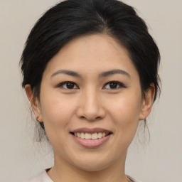 Joyful asian young-adult female with medium  brown hair and brown eyes