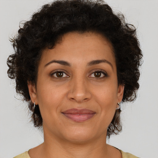 Joyful latino young-adult female with short  brown hair and brown eyes