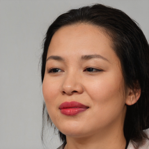 Joyful asian young-adult female with medium  brown hair and brown eyes