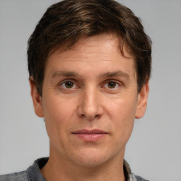 Joyful white adult male with short  brown hair and grey eyes