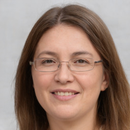 Joyful white adult female with long  brown hair and grey eyes