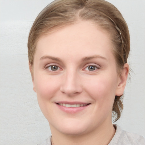 Joyful white young-adult female with medium  brown hair and blue eyes