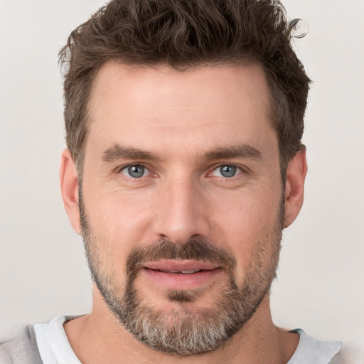 Joyful white adult male with short  brown hair and grey eyes