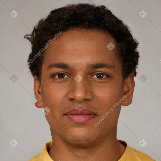 Joyful black young-adult male with short  brown hair and brown eyes