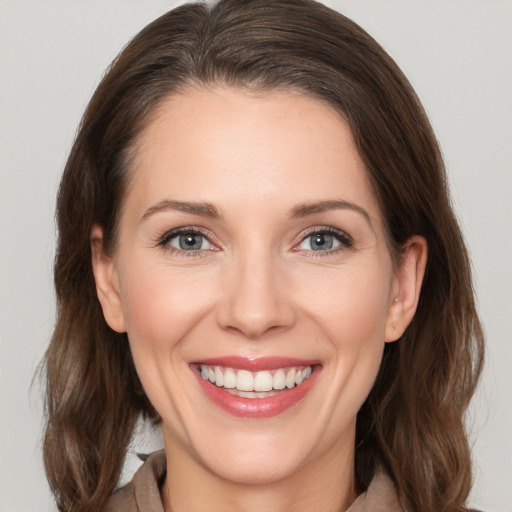 Joyful white young-adult female with medium  brown hair and brown eyes