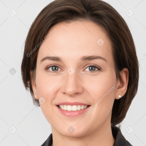 Joyful white young-adult female with medium  brown hair and grey eyes