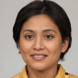 Joyful white adult female with medium  brown hair and brown eyes