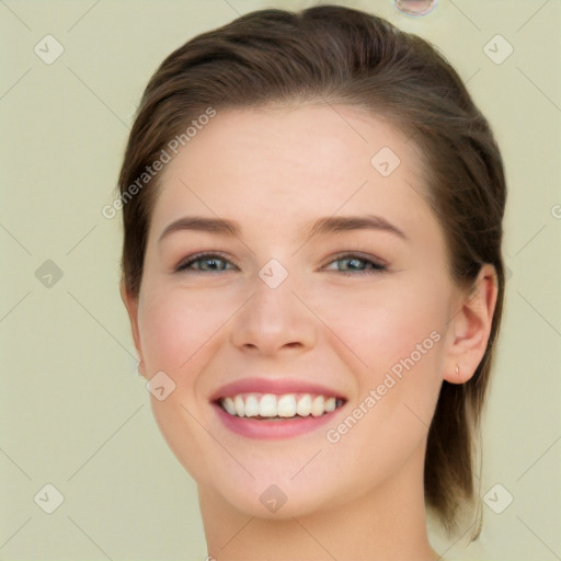 Joyful white young-adult female with long  brown hair and green eyes