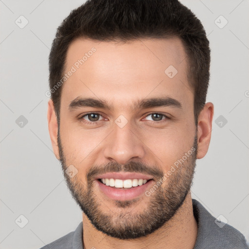 Joyful white young-adult male with short  brown hair and brown eyes