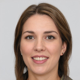 Joyful white young-adult female with long  brown hair and green eyes